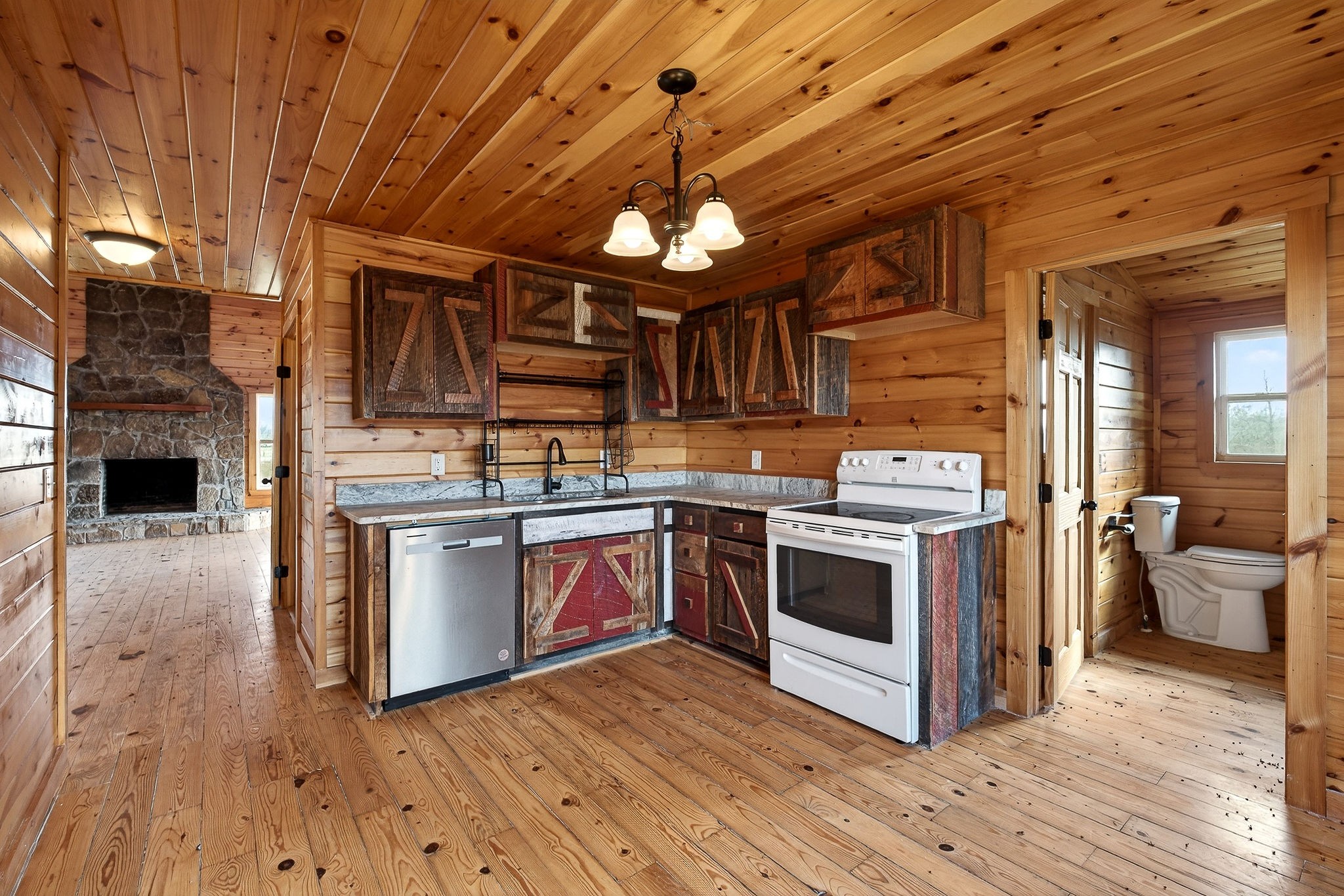 6425 Plateau Road Crossville, TN 38571 - Photo 12 of 42 a kitchen with stainless steel appliances granite countertop a stove a sink and a microwave