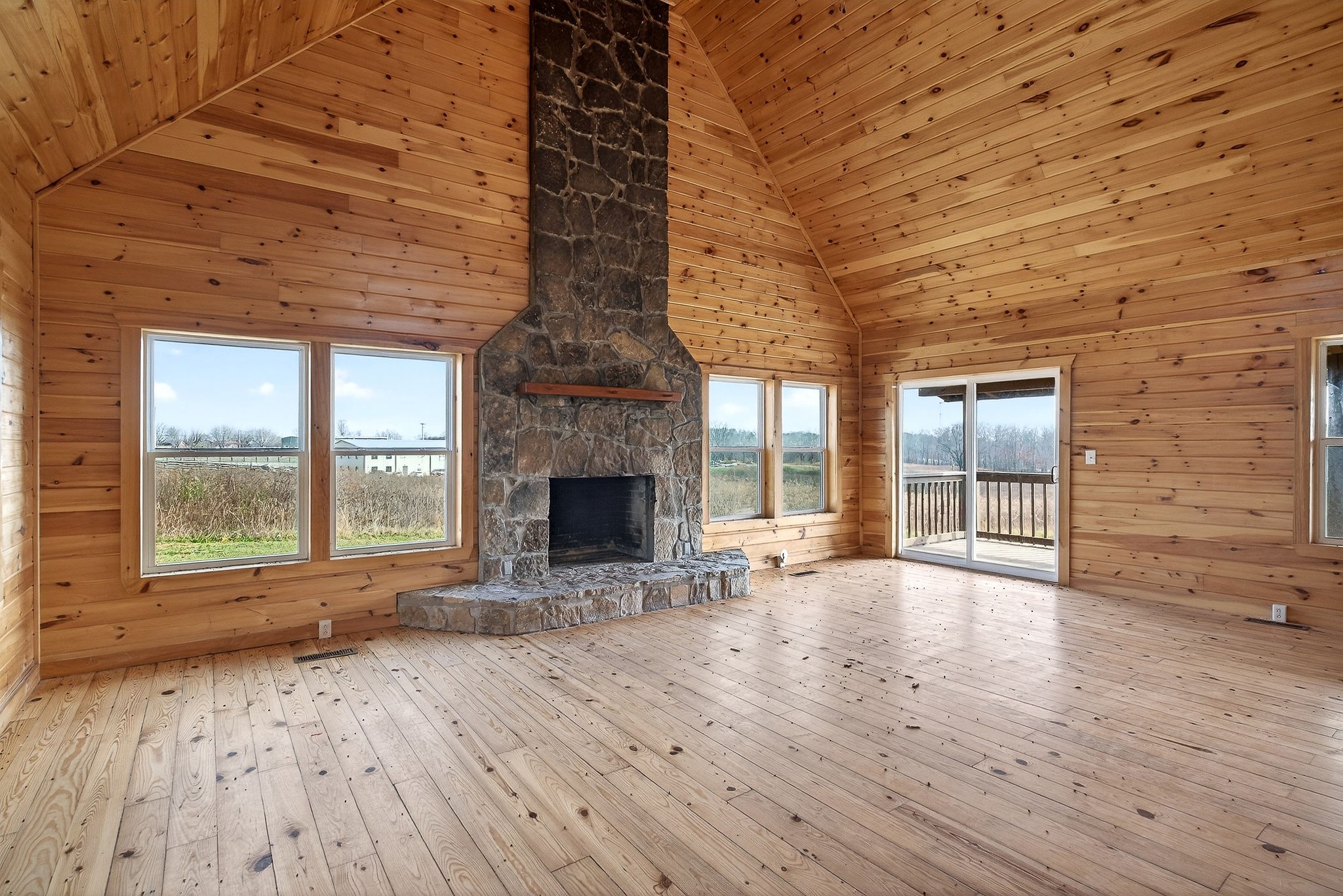 6425 Plateau Road Crossville, TN 38571 - Photo 4 of 42 an empty room with wooden floor and fireplace