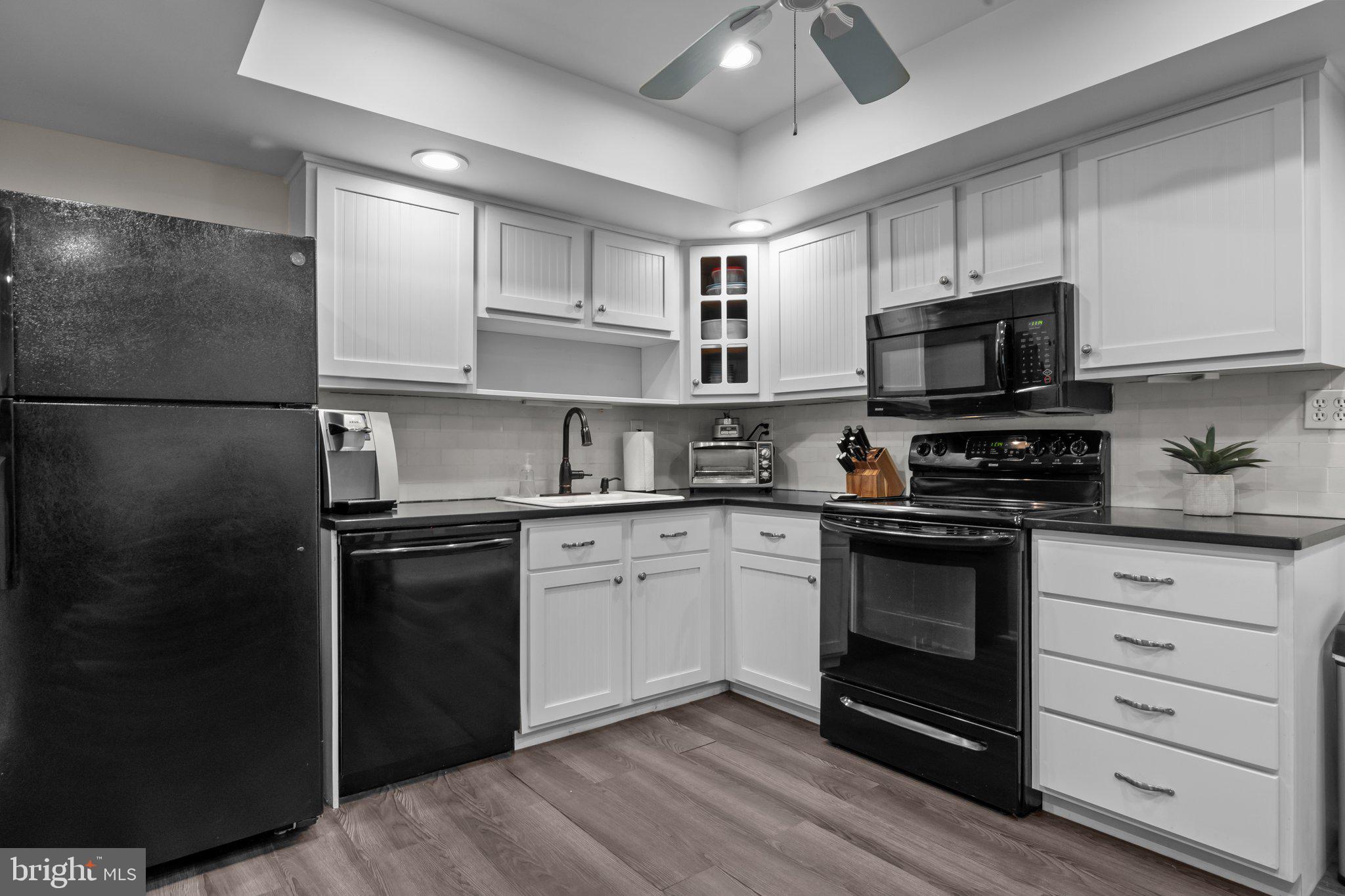 609 Hampton Court Doylestown, PA 18901 - Photo 15 of 41 a kitchen with granite countertop a refrigerator stove and white cabinets