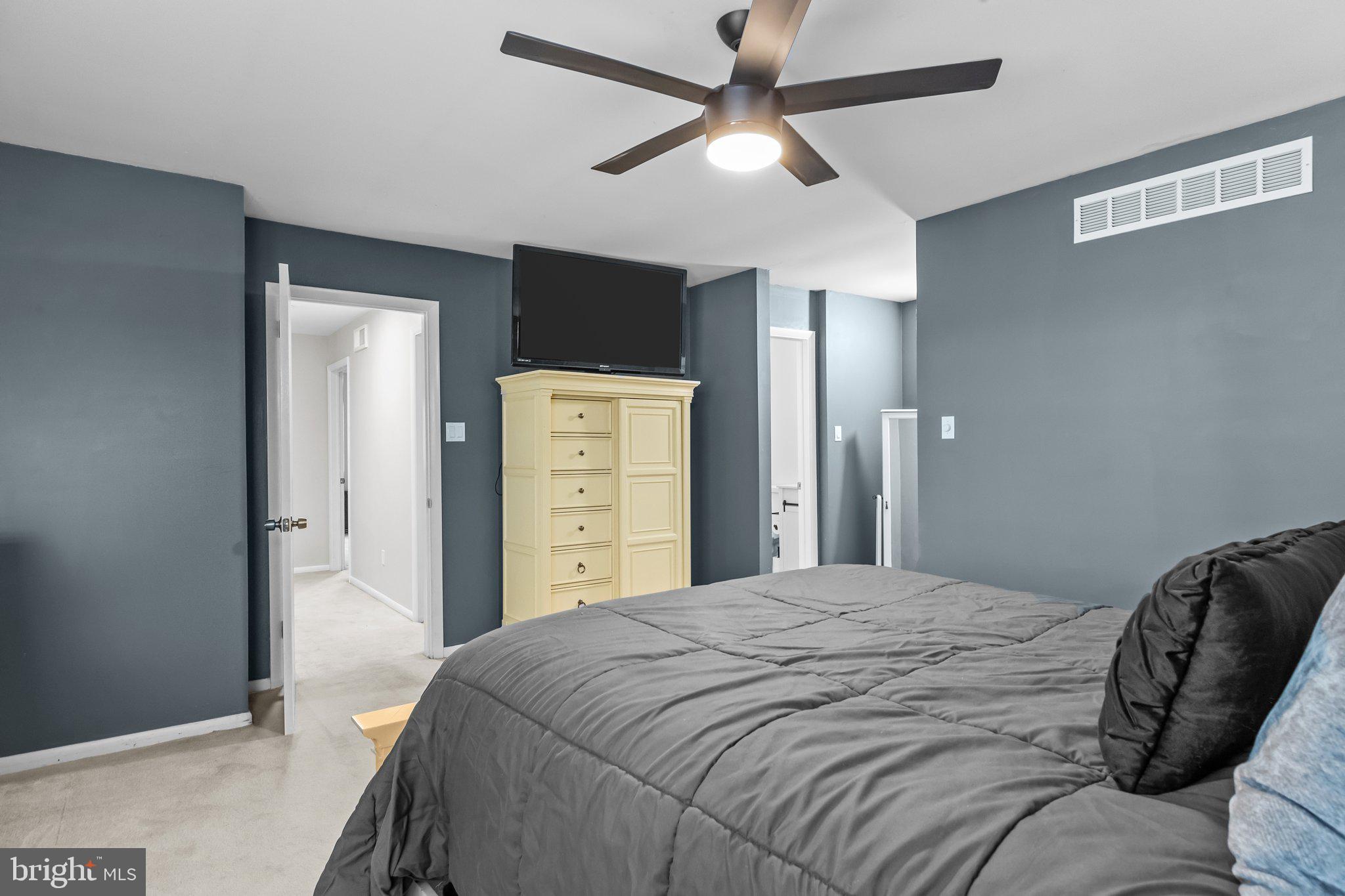 609 Hampton Court Doylestown, PA 18901 - Photo 28 of 41 a bedroom with a bed and a chandelier