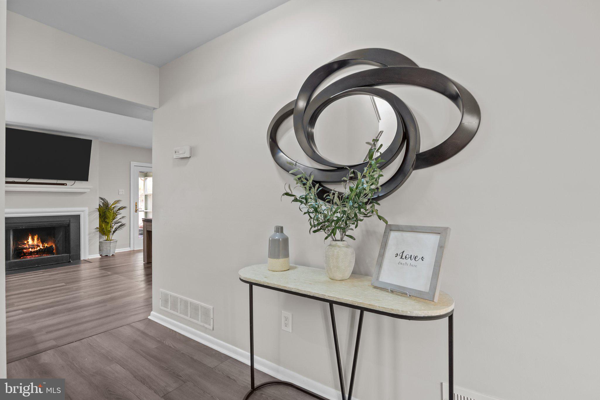 609 Hampton Court Doylestown, PA 18901 - Photo 5 of 41 a dining room with furniture a fireplace and a mirror