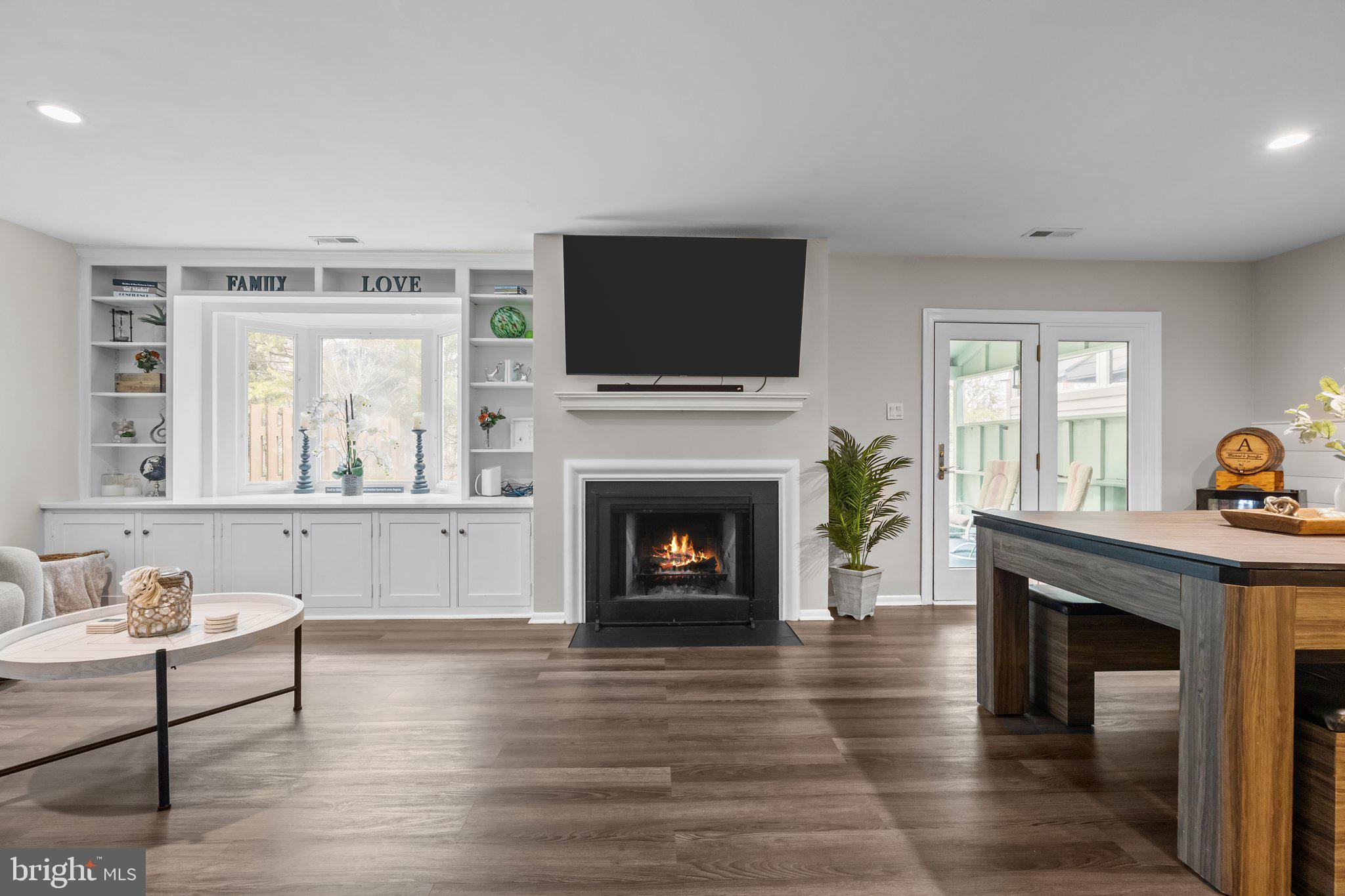 609 Hampton Court Doylestown, PA 18901 - Photo 9 of 41 a living room with furniture a flat screen tv and a fireplace