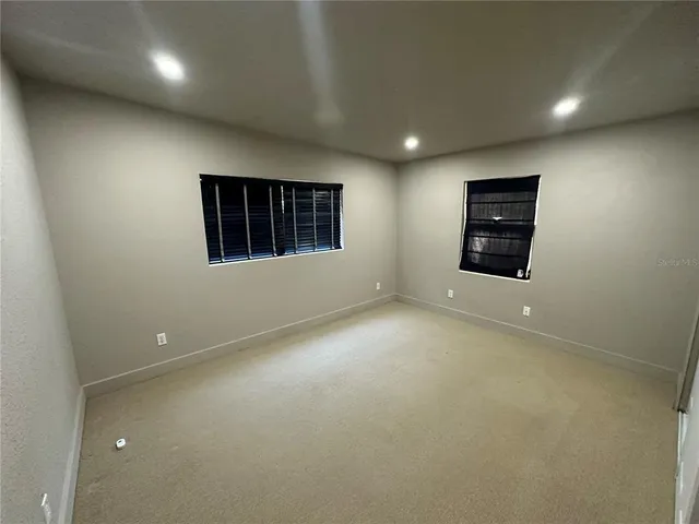 an empty room with a window and fireplace