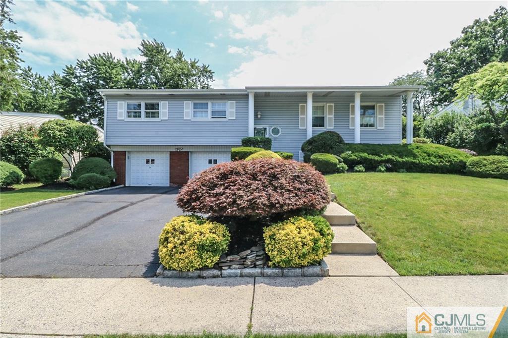 64 Harmon Road Edison, NJ 08837 - Photo 1 of 15 a front view of a house with garden