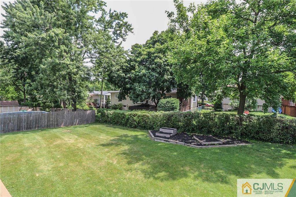 64 Harmon Road Edison, NJ 08837 - Photo 14 of 15 a view of a backyard with large trees and plants