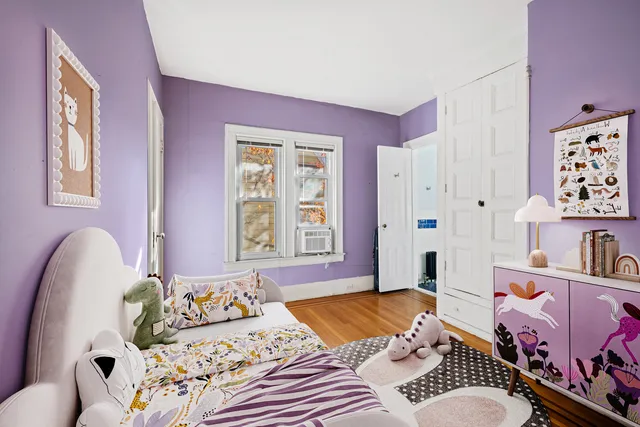 a bedroom with a bed and a large window with outer view