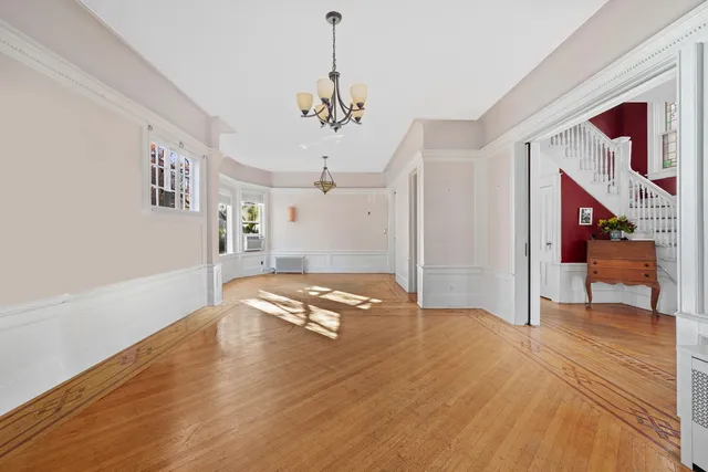 a living room with furniture a rug and a chandelier