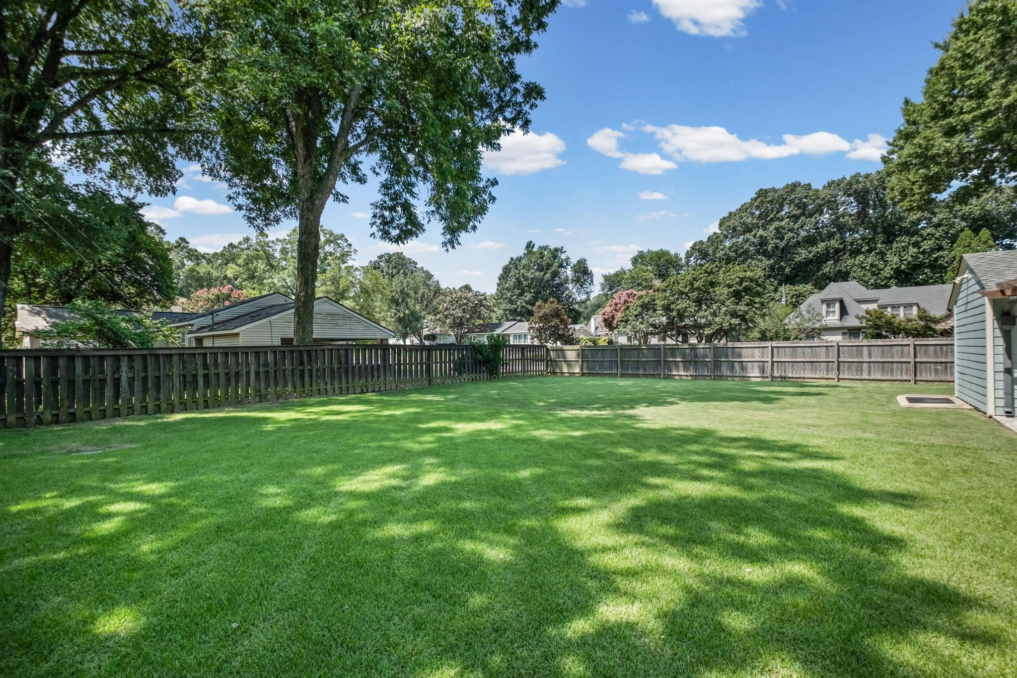 5079 Walnut Grove Road Memphis, TN 38117 - Photo 32 of 40 Expansive grassy lawn with a full privacy fence