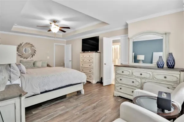 a bedroom with a large bed and flat tv screen