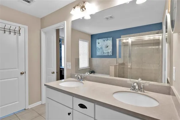 a bathroom with a sink double vanity and a mirror