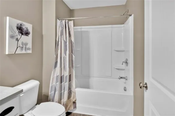 a bathroom with a toilet and a bathtub