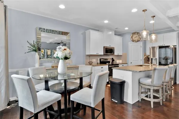 a view of a dining room with furniture and wooden floor