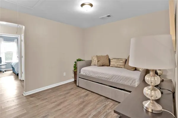 a bedroom with a bed and wooden floor