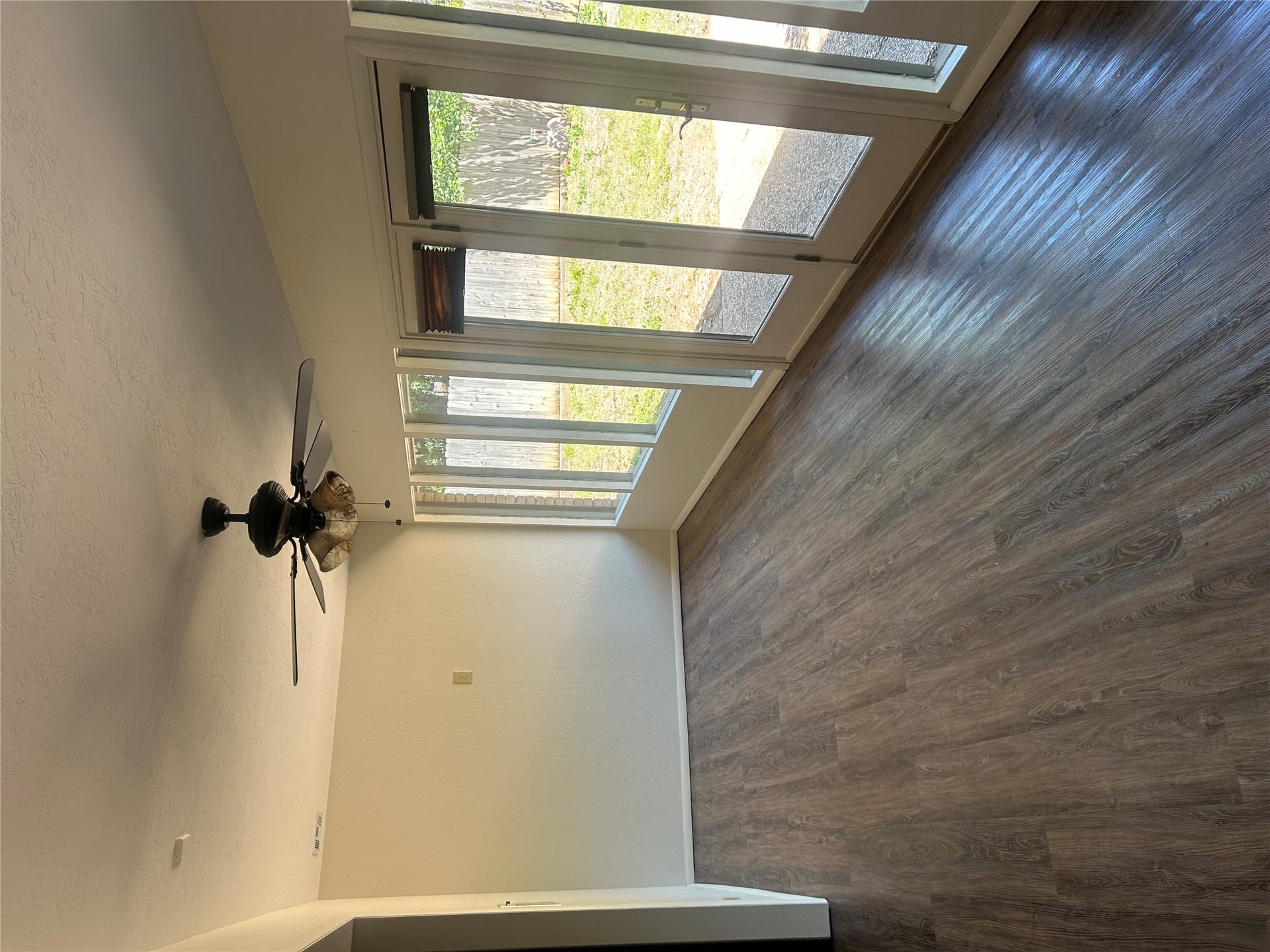 2913 Springdale Lane Duncan, OK 73533 - Photo 23 of 32 Wood-finish flooring, ceiling fan with integrated lighting, multiple windows, and French doors providing access to the exterior