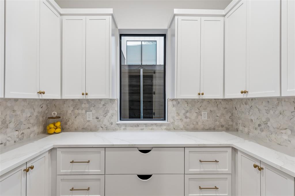 4311 Merrell Road Dallas, TX 75229 - Photo 13 of 30 a kitchen with granite countertop white cabinets and sink