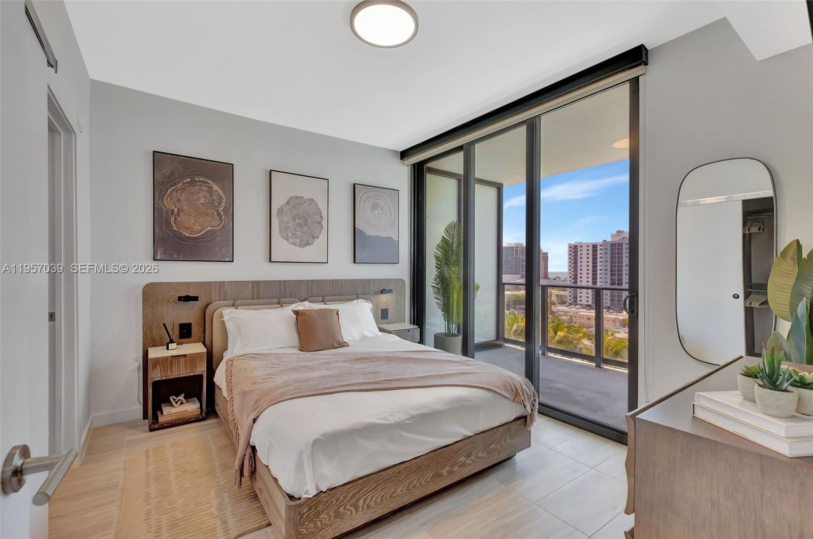 580 72nd Street, Unit 808 Miami Beach, FL 33141 - Photo 12 of 29 a bedroom with a large bed and a painting on the wall