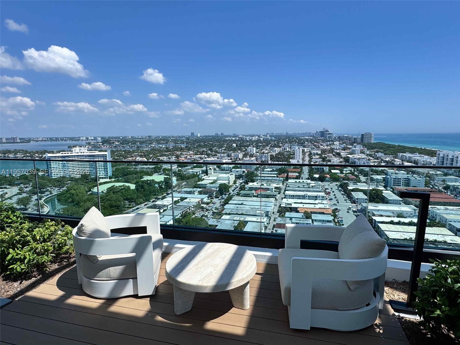 580 72nd Street, Unit 808 Miami Beach, FL 33141 - Photo 19 of 29 a view of a chairs and table in a terrace