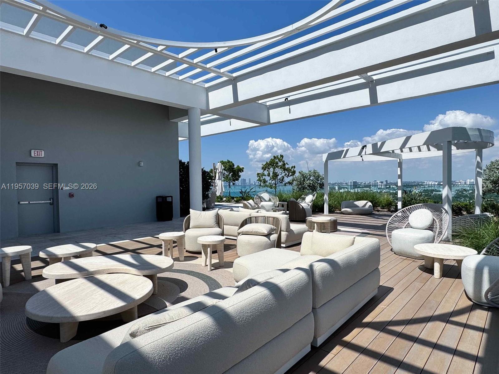 580 72nd Street, Unit 808 Miami Beach, FL 33141 - Photo 21 of 29 a living room with furniture and a chandelier