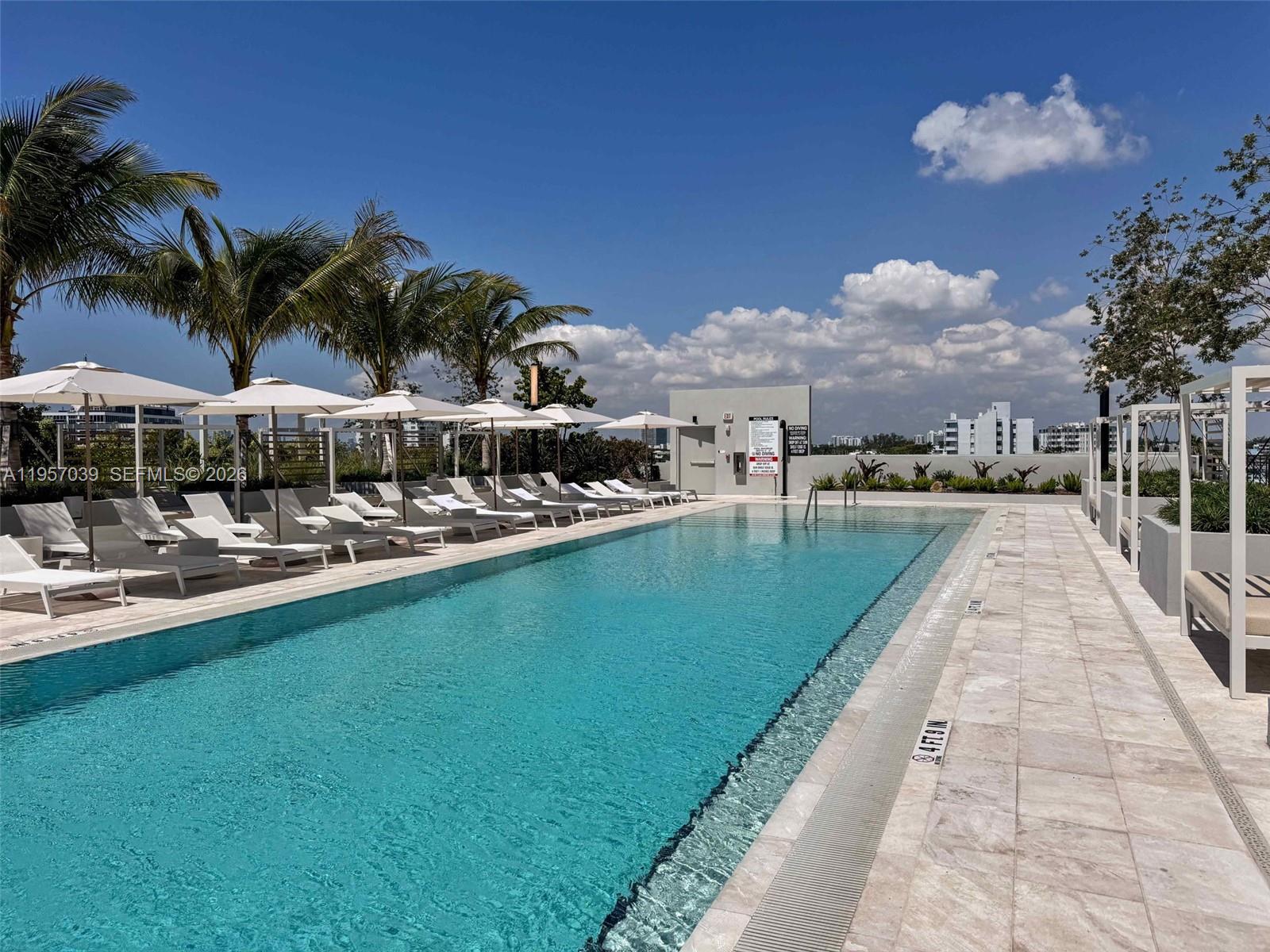 580 72nd Street, Unit 808 Miami Beach, FL 33141 - Photo 26 of 29 a view of swimming pool with outdoor seating and city view