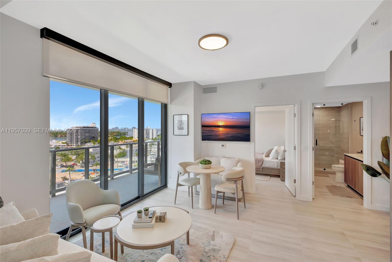 580 72nd Street, Unit 808 Miami Beach, FL 33141 - Photo 3 of 29 a living room with furniture and a flat screen tv