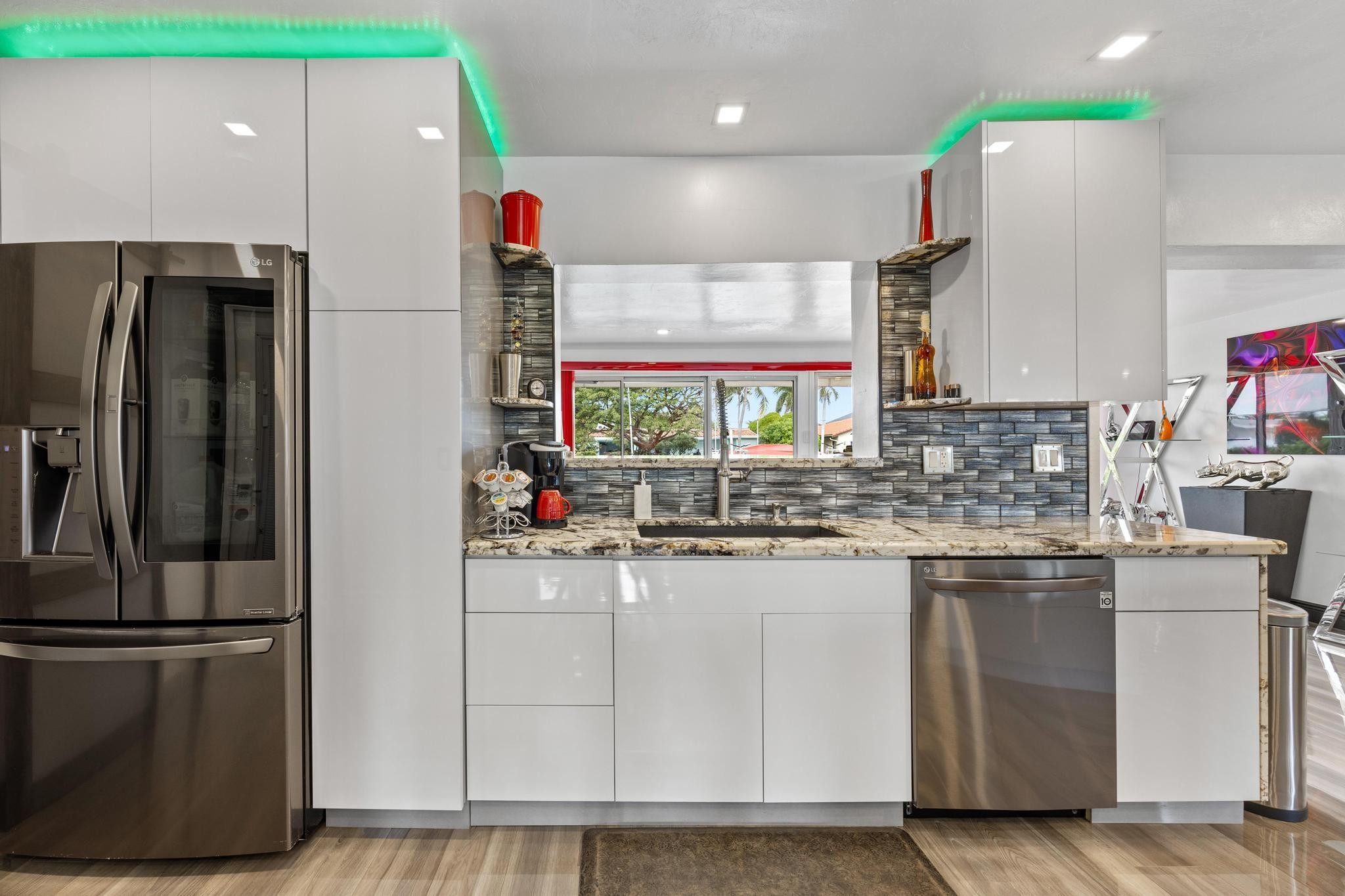 2531 Northeast 47th Street Lighthouse Point, FL 33064 - Photo 12 of 52 a kitchen with stainless steel appliances granite countertop a refrigerator and a sink