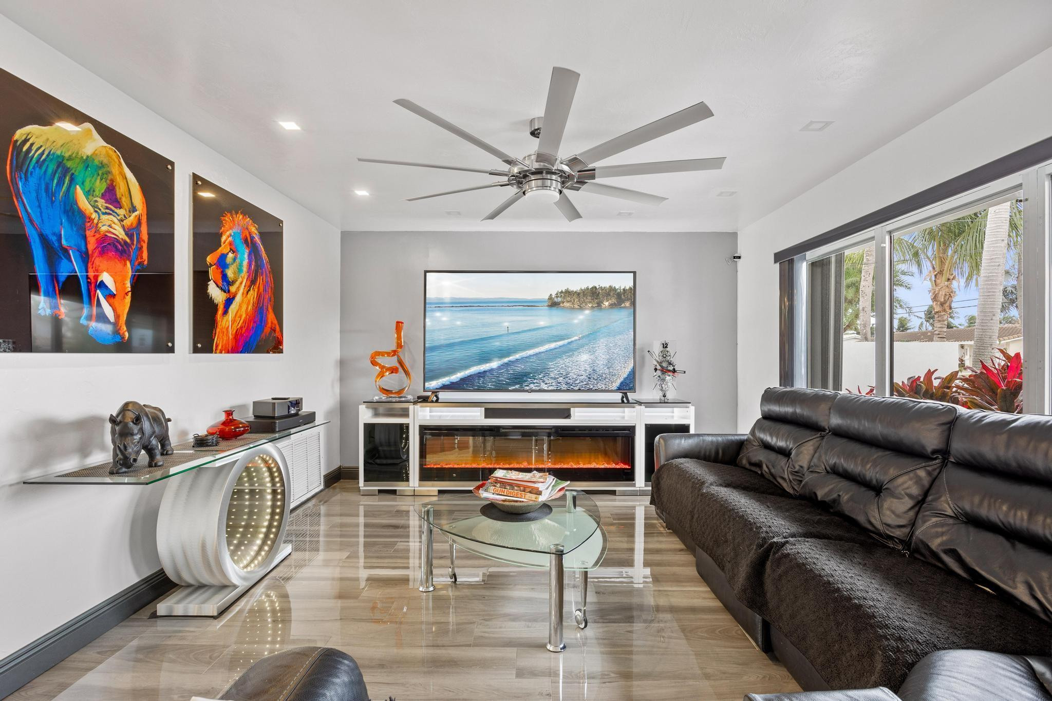 2531 Northeast 47th Street Lighthouse Point, FL 33064 - Photo 21 of 52 a living room with furniture a fireplace and a flat screen tv