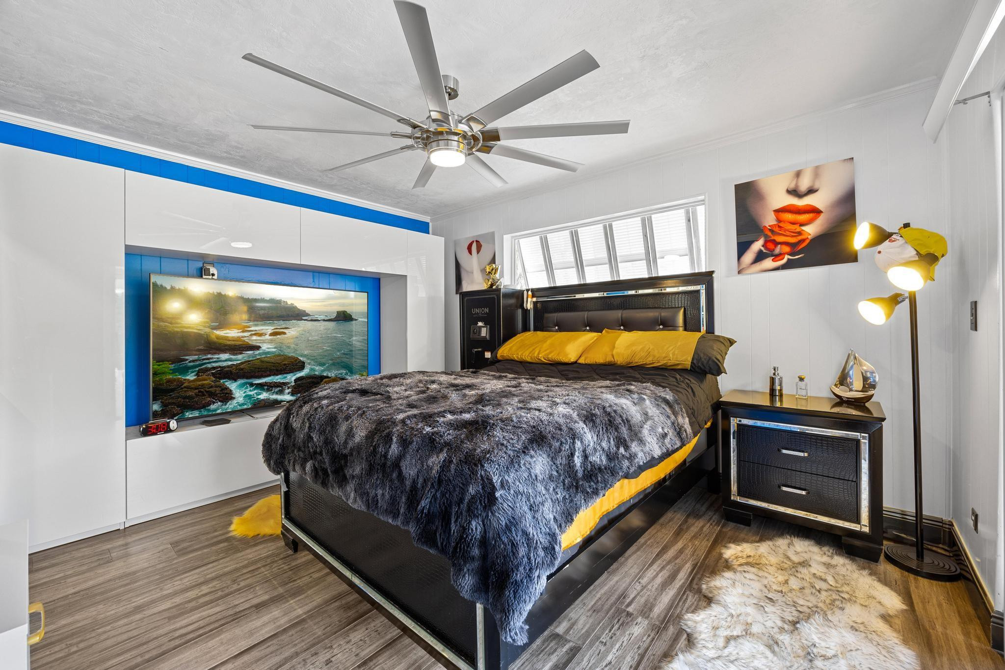 2531 Northeast 47th Street Lighthouse Point, FL 33064 - Photo 36 of 52 a bedroom with a bed and a chandelier