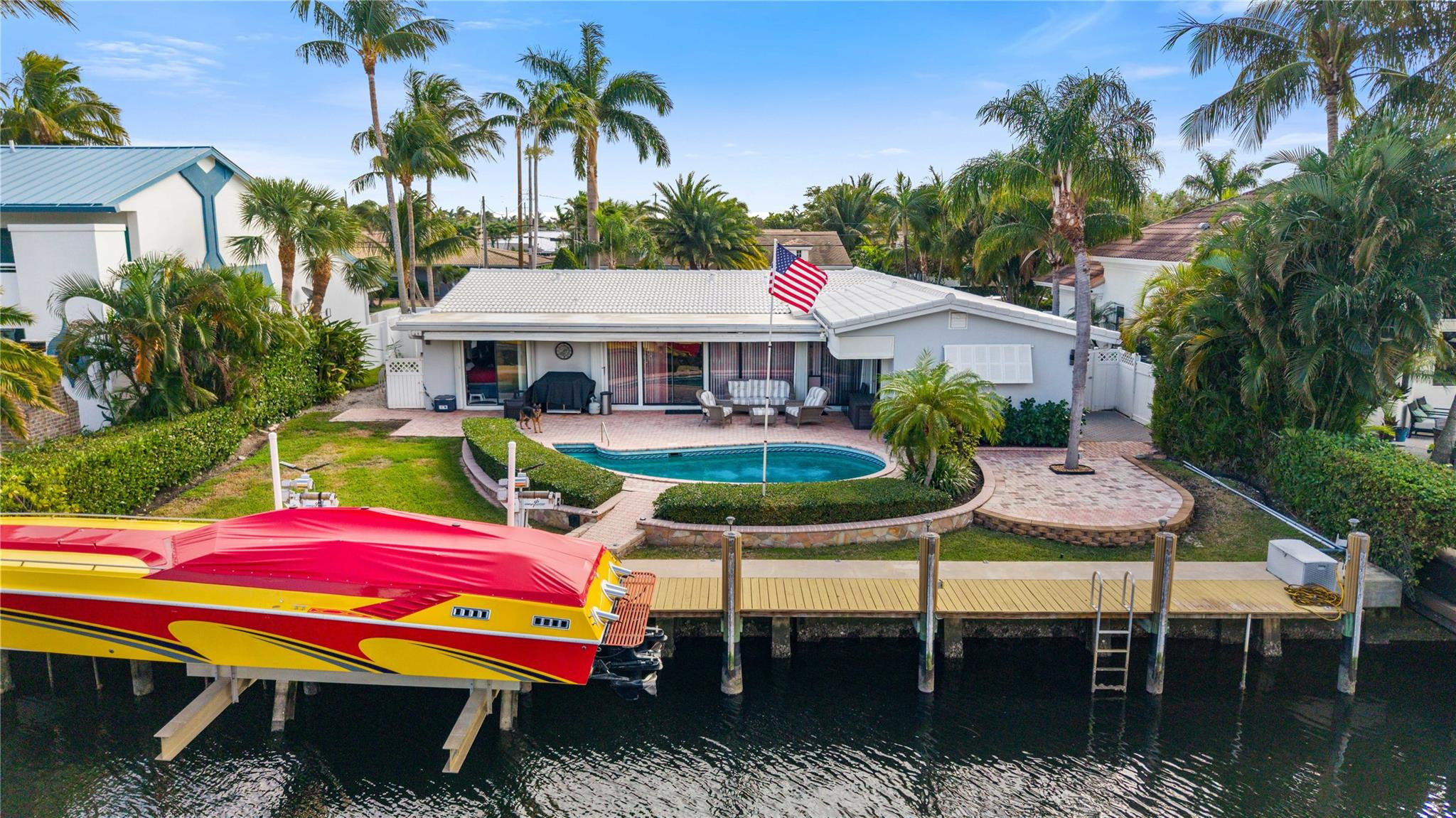 2531 Northeast 47th Street Lighthouse Point, FL 33064 - Photo 4 of 52 a patio with tables and chairs pool fire pit and next to a yard