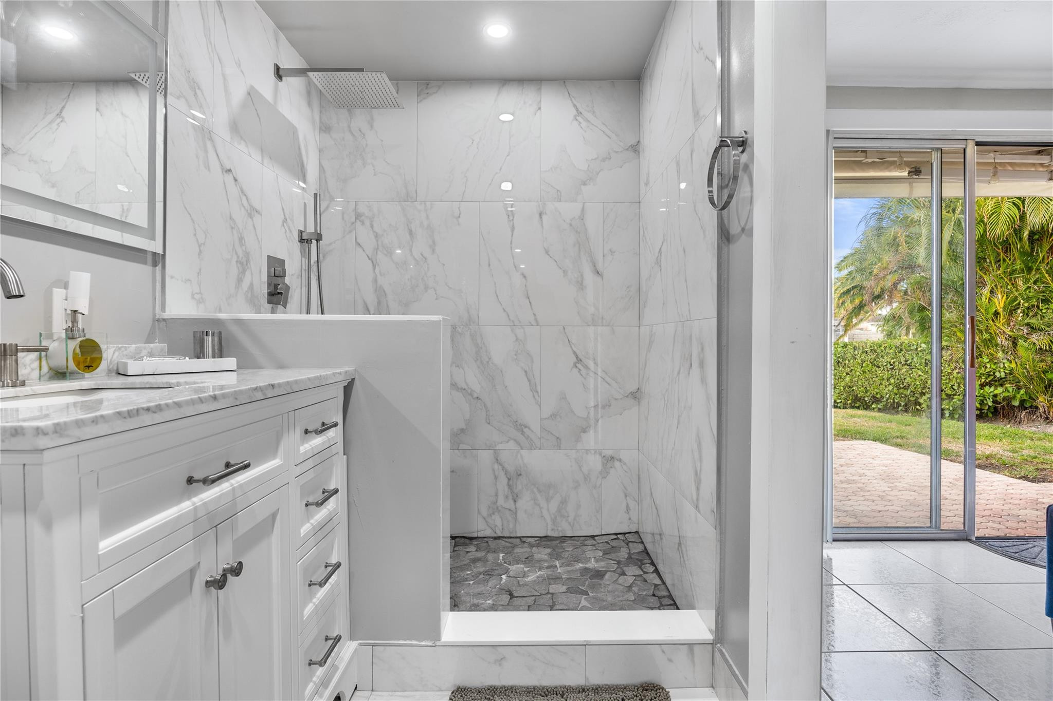 2531 Northeast 47th Street Lighthouse Point, FL 33064 - Photo 45 of 52 a bathroom with a sink and a mirror