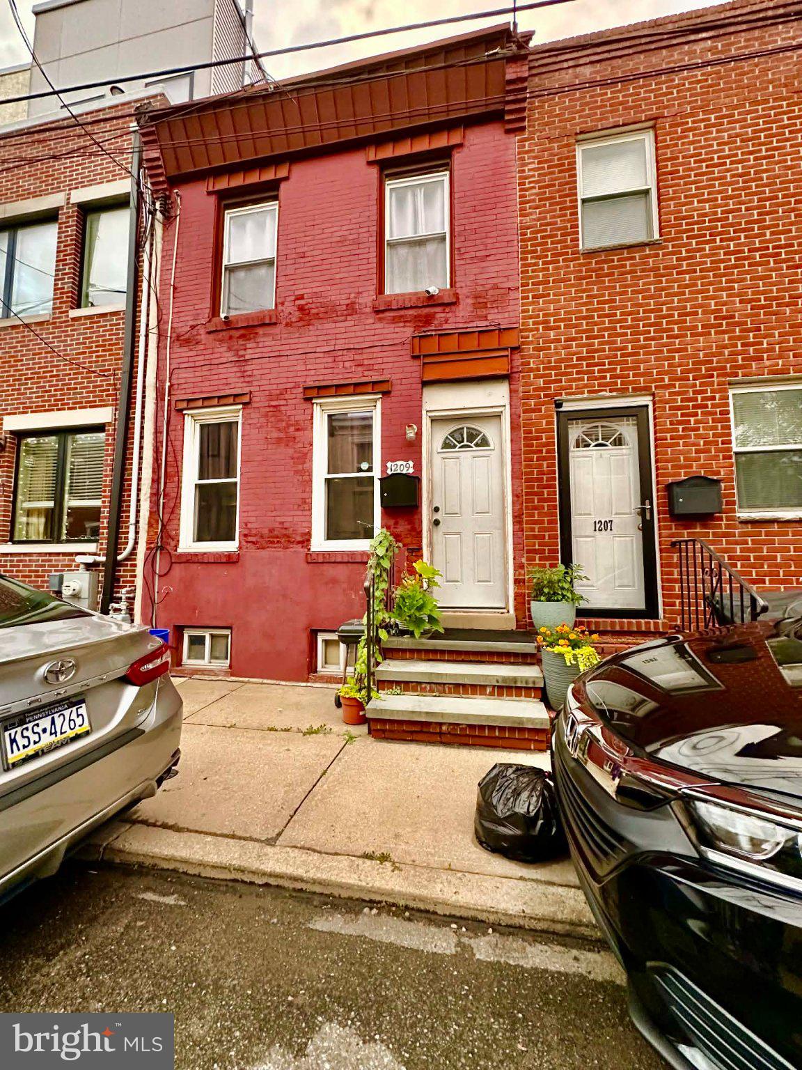 1209 Peters Street Philadelphia, PA 19147 - Photo 13 of 13 Charming red brick townhouse facade.