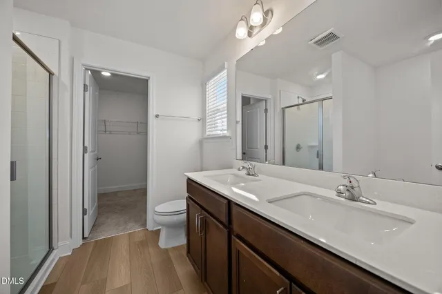 a white bath tub sitting next to a white sink and vanity