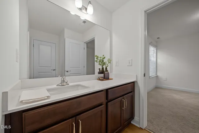 a bathroom with a sink double vanity and a mirror