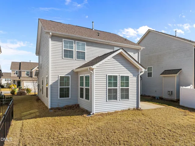 a view of a patio with swimming pool and couches chairs
