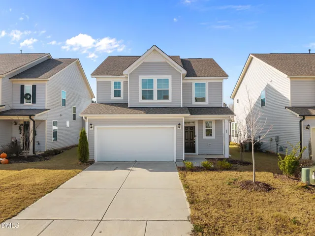 an aerial view of multiple houses with yard