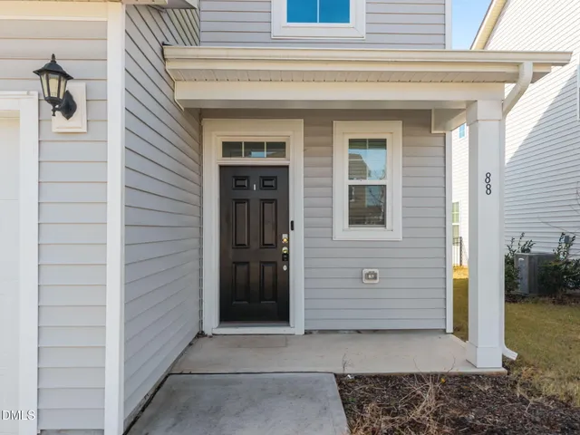 an aerial view of a residential houses with outdoor space and parking