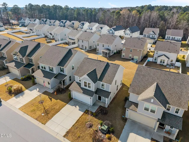 an aerial view of residential houses with outdoor space