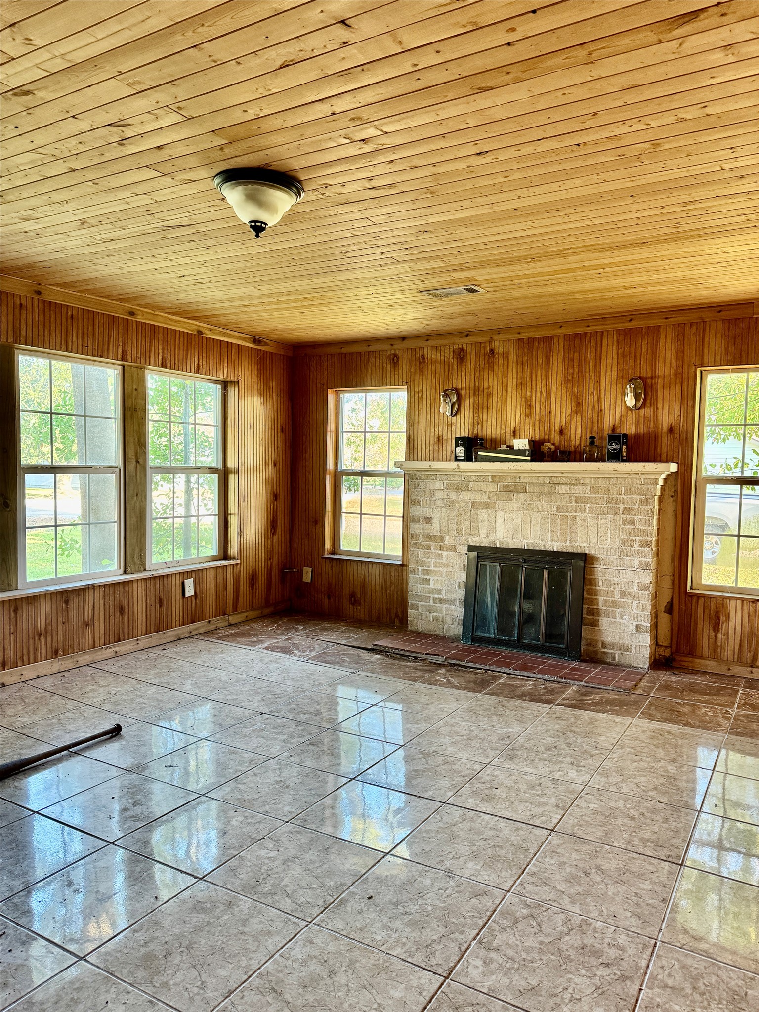 2340 19th Street Port Arthur, TX 77640 - Photo 13 of 13 a view of an empty room with a fireplace and a window