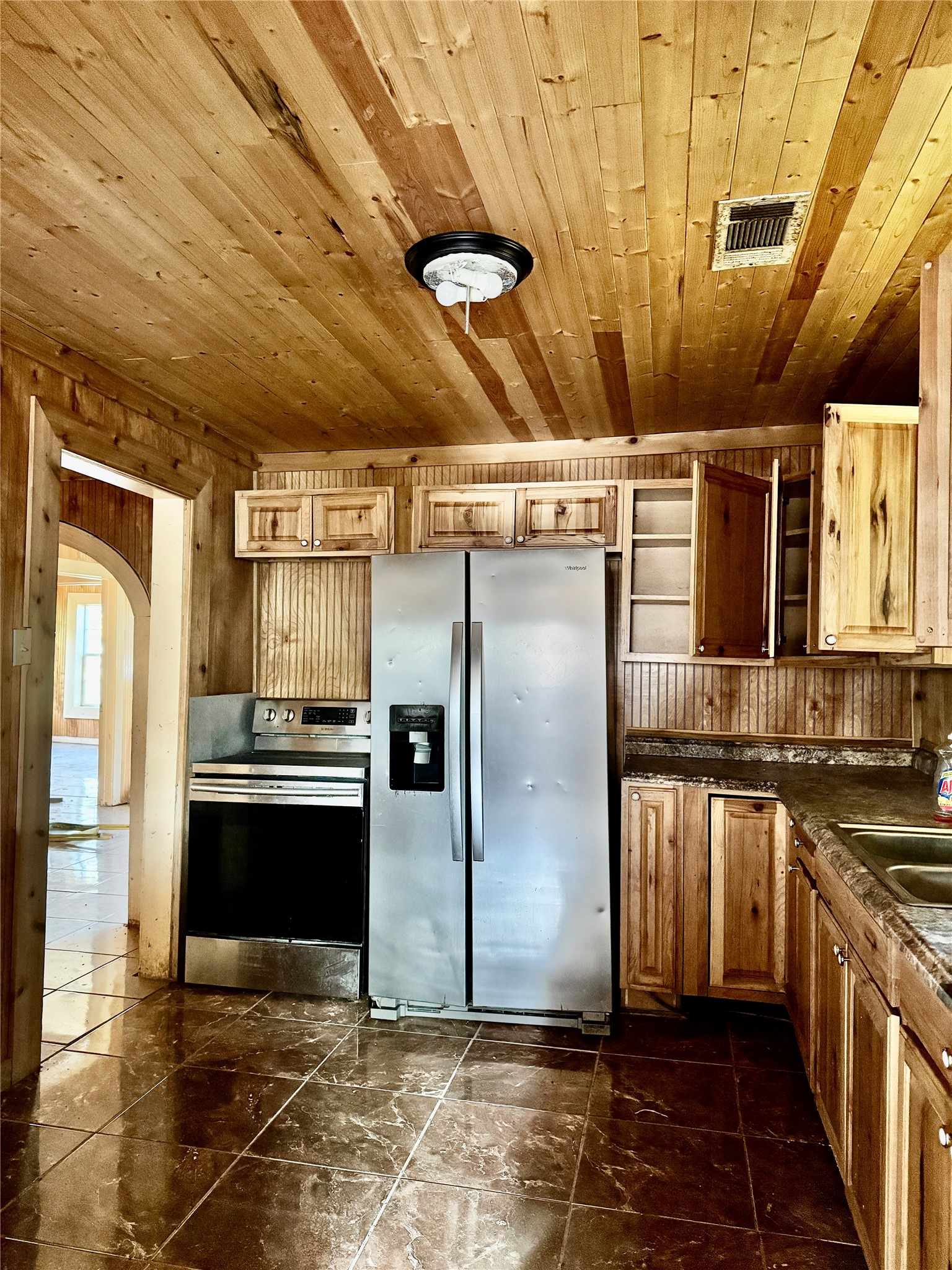 2340 19th Street Port Arthur, TX 77640 - Photo 7 of 13 a kitchen with stainless steel appliances granite countertop a refrigerator a stove and a sink