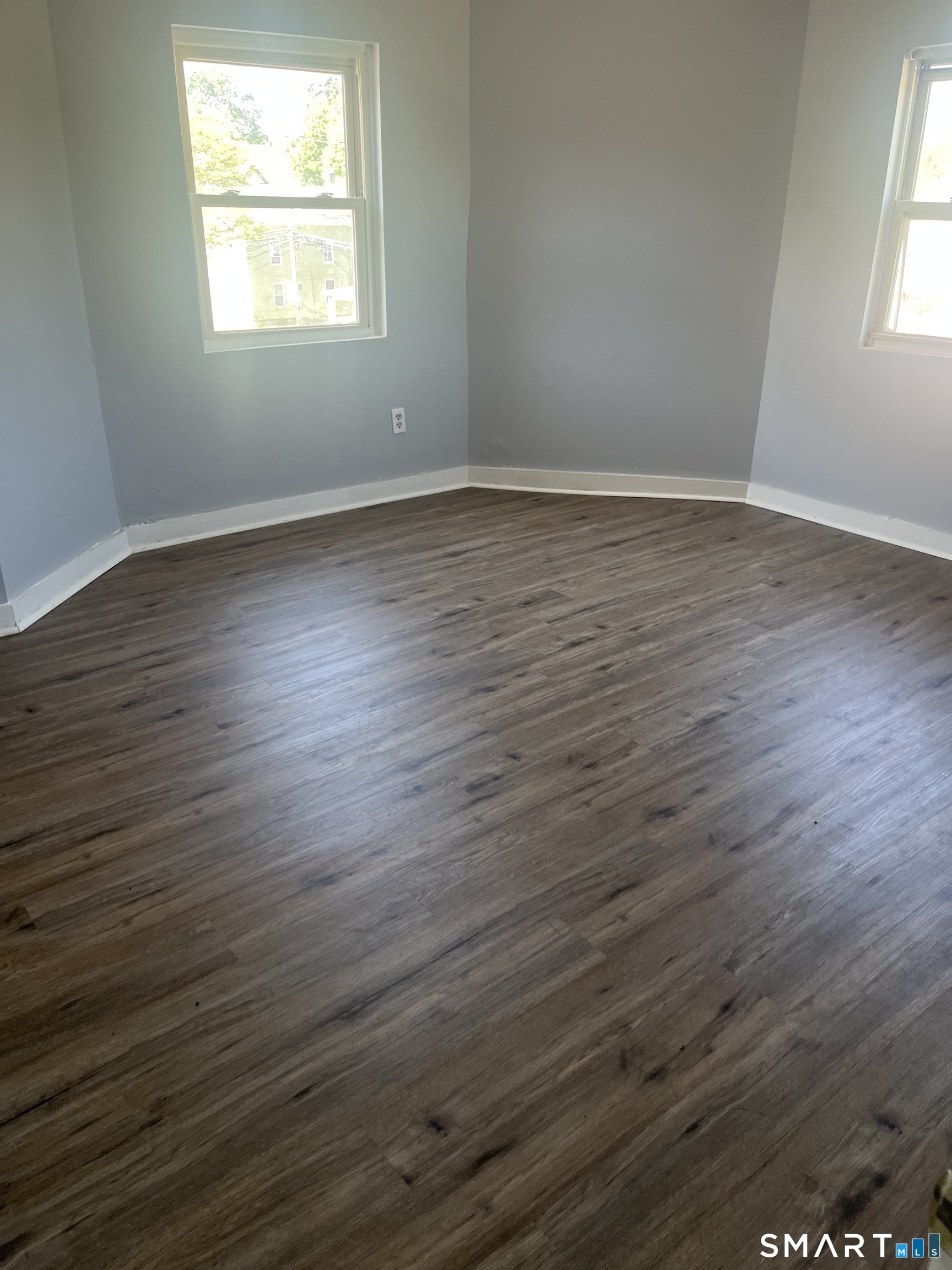 288 Cook Avenue Meriden, CT 06451 - Photo 5 of 11 an empty room with wooden floor and windows