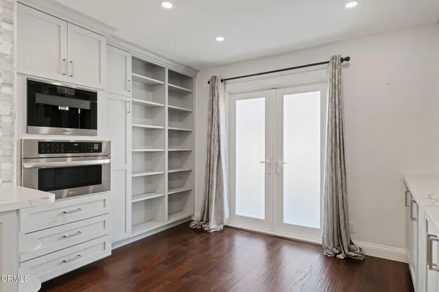 a view of an empty room with cabinet and flat screen tv