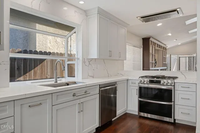 a kitchen with a stove and a sink