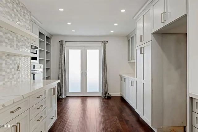 a view of hallway with wooden floor
