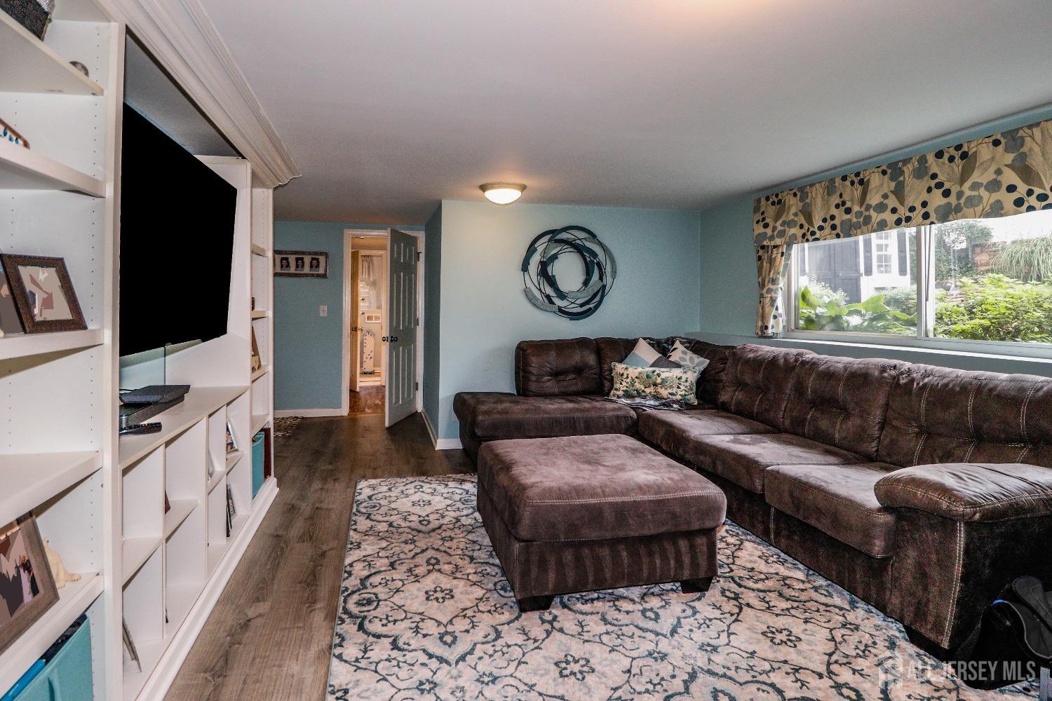 38 Westminster Road Colonia, NJ 07067 - Photo 11 of 24 a living room with furniture and a flat screen tv