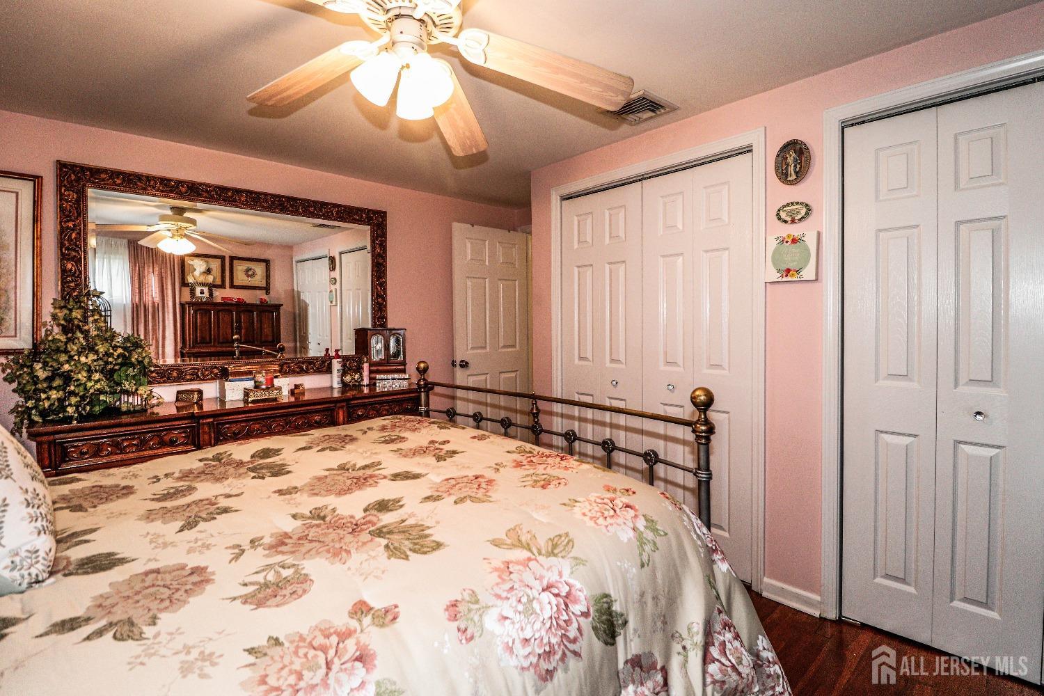 38 Westminster Road Colonia, NJ 07067 - Photo 17 of 24 a bedroom with a large bed and a chandelier