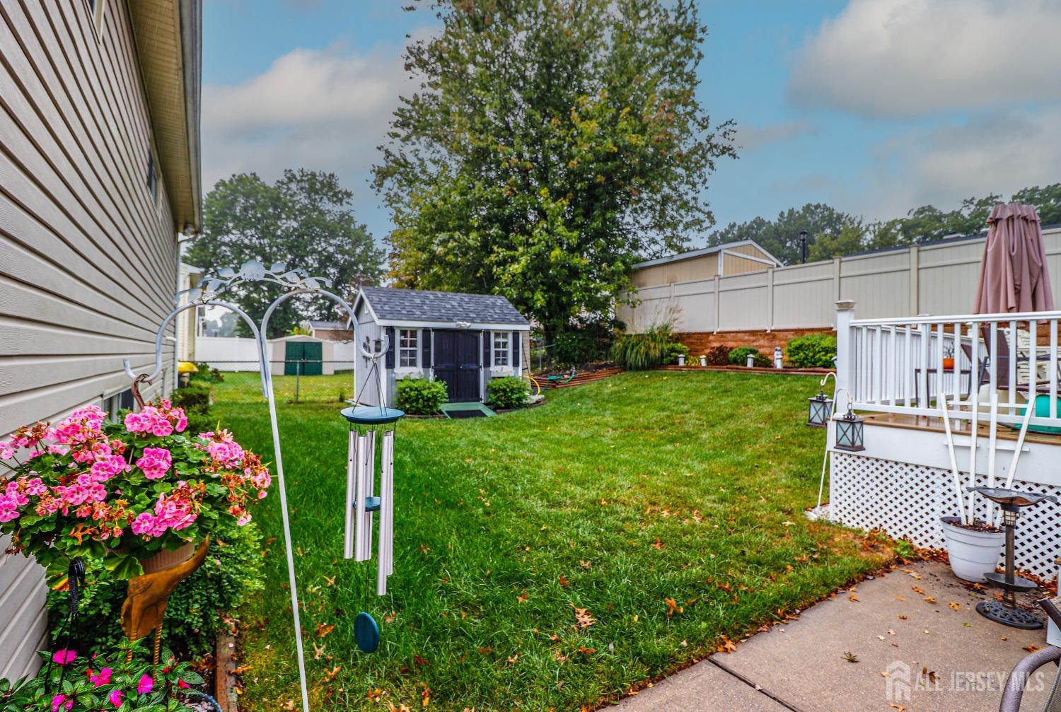 38 Westminster Road Colonia, NJ 07067 - Photo 22 of 24 a front view of a house with a yard and fountain in middle of the road