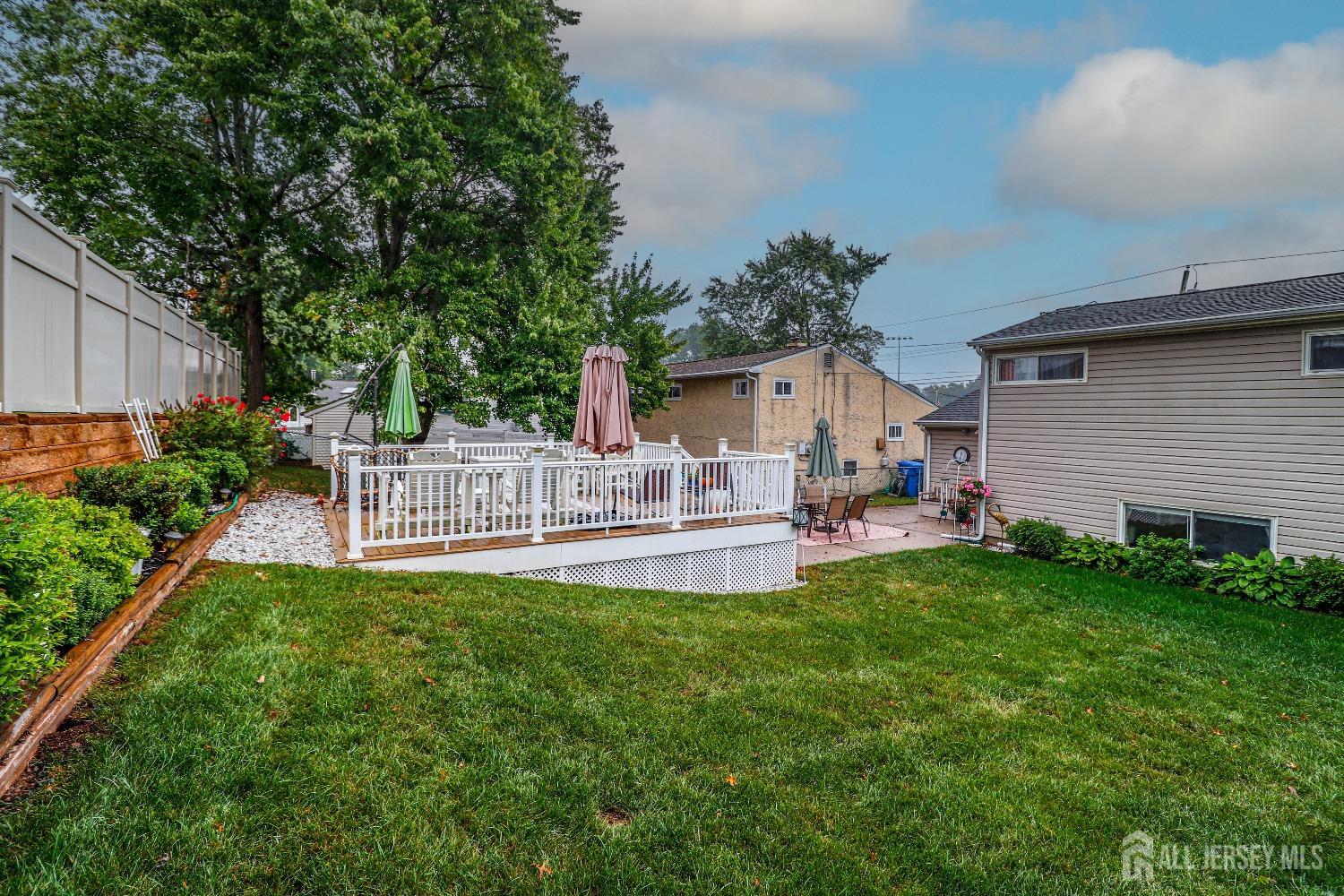 38 Westminster Road Colonia, NJ 07067 - Photo 23 of 24 a view of a patio with table and chairs potted plants and large tree