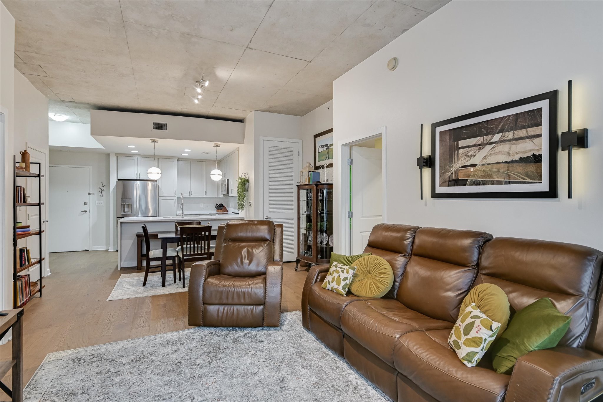 360 Nueces Street, Unit 1405 Austin, TX 78701 - Photo 24 of 40 a living room with furniture and a dining table with kitchen view