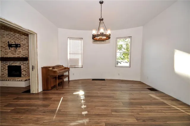 a view of livingroom with window fireplace and wooden floor