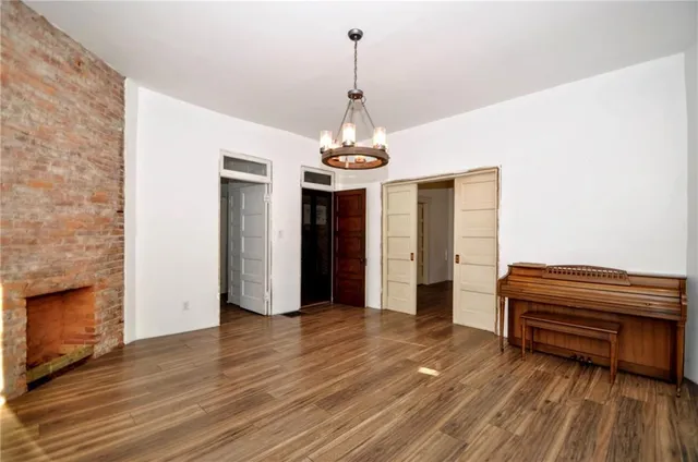a view of a livingroom with wooden floor and a ceiling fan