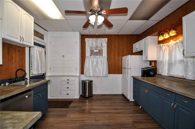 a kitchen with cabinets wooden floor and a sink
